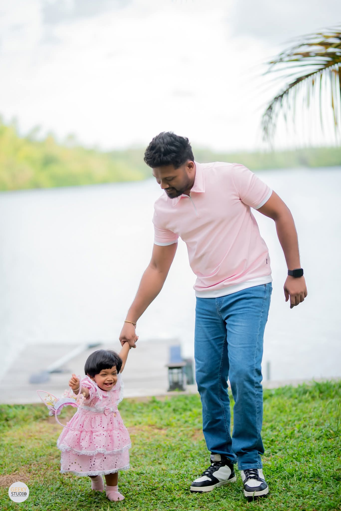 Father walking with baby daughter beside Rathgama Lake at AquaTrek birthday celebration