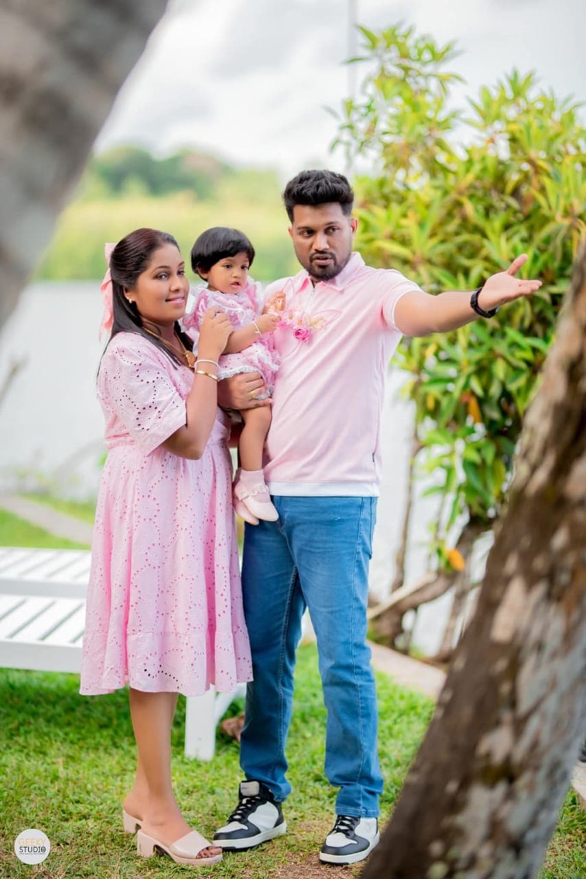 Family of three posing in the lakeside garden at AquaTrek Water Adventures, Hikkaduwa