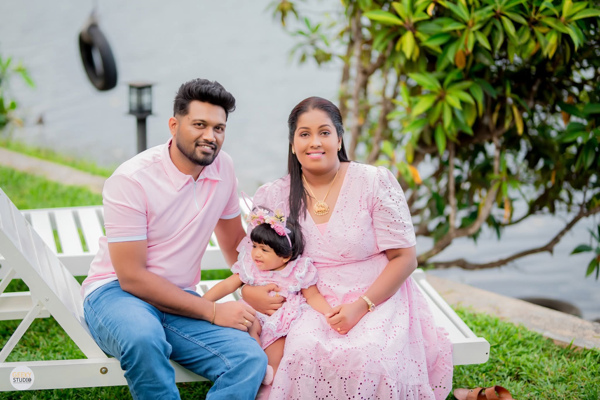 Family portrait with baby daughter on a lakeside bench at AquaTrek birthday celebration, Hikkaduwa